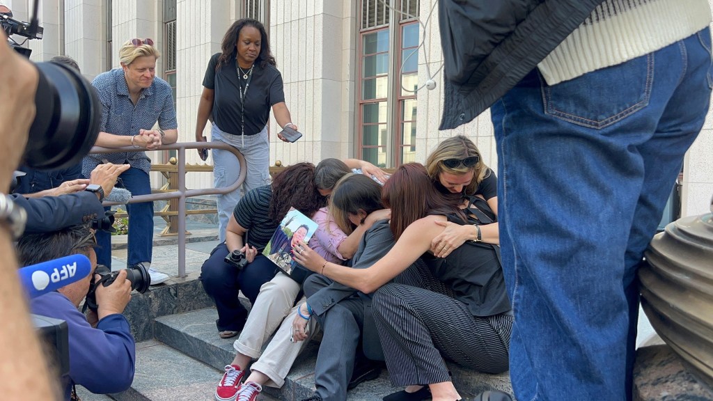 Parents hugging on the courtroom steps after the verdict